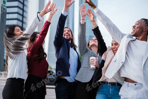 Preview: Business group celebrating the successes of the company outdoors in the financial district