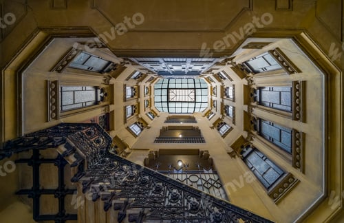 Preview: Low angle shot of the geometrical stairway of an old building