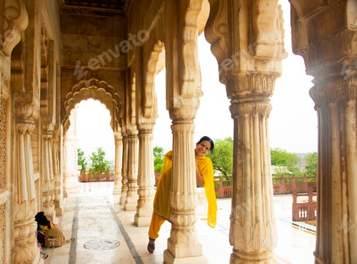 Preview: Indian woman standing between arches and Pillars.
