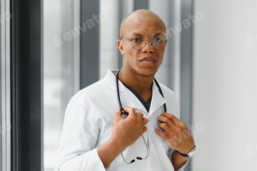 Preview: African American man male hospital doctor in white coat with stethoscope.