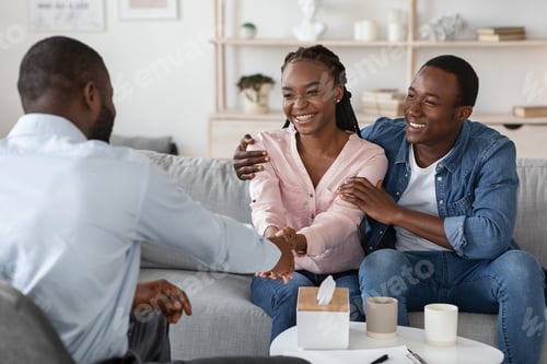 Preview: After Effective Therapy. Joyful Black Couple Handshaking With Marital Counselor After Session