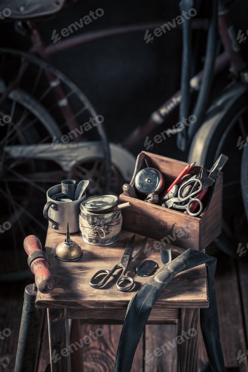 Preview: Retro bicycle repair workshop with tools, wheels and tube