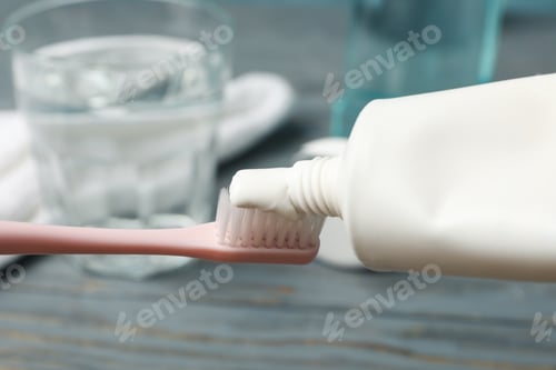 Preview: Toothbrush with toothpaste on background with dental care tools, close up