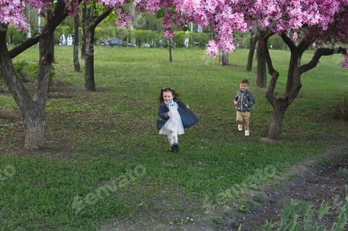 Preview: Happy happy kids running on the grass in the park