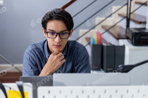 Preview: Young man committed working look at computer. Male office worker