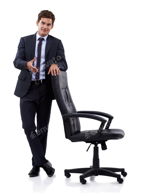 Confident Man in Suit Standing by Executive Chair