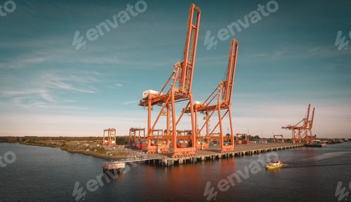 Preview: Big metal ship cranes at a dock with the blue sky in the background on a sunny day