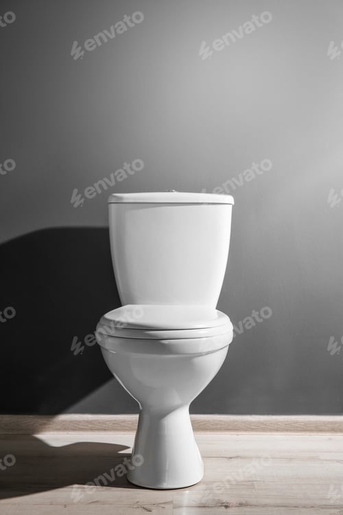 Preview: New ceramic toilet bowl near grey wall, side light