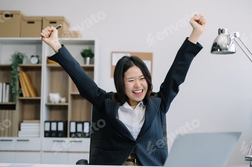 Preview: Excited Business Woman Celebrating Success in Office