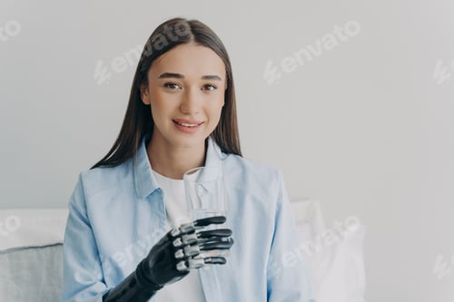Preview: Disabled girl grasps a glass with myoelectric hand. High technology prosthesis.