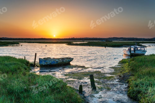 Preview: Summer sunrise over old boats on the shores of Holes Bay