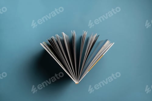 Preview: a directly above view of the opened book on pastel background, spreaded pages