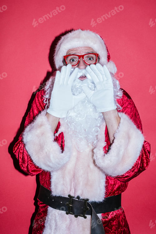 Preview: Man dressed as Santa Claus gesturing with funny glasses
