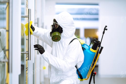 Preview: Cleaning and disinfection of office to prevent COVID-19, Man in protective hazmat suit washes office