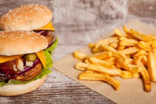 Preview: Home made cheeseburgers on wooden plate
