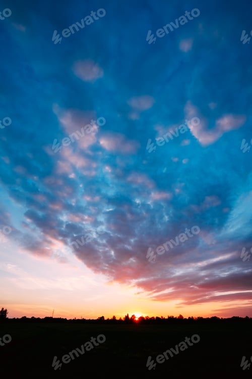 Preview: Sunset, Sunrise Over Rural Field Meadow. Bright Dramatic Sky And