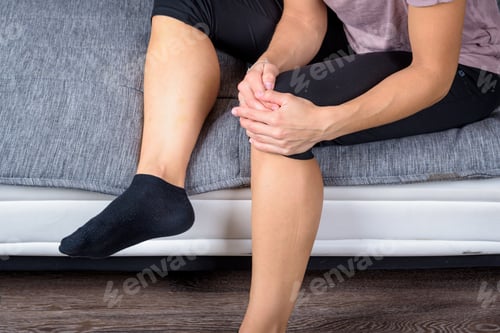 Preview: Close-up of woman’s legs stretching with her hands