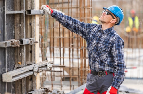 Preview: Construction Worker Adjusting Scaffolding in Urban Site Setting