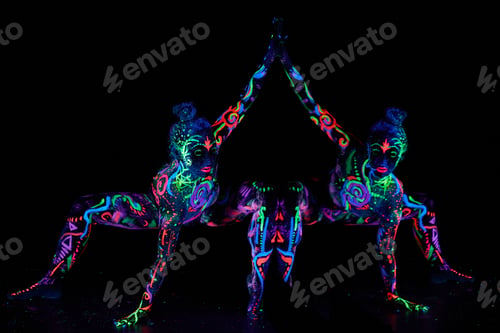 Preview: Art woman body art on the body dancing in ultraviolet light. Bright woman body neon color