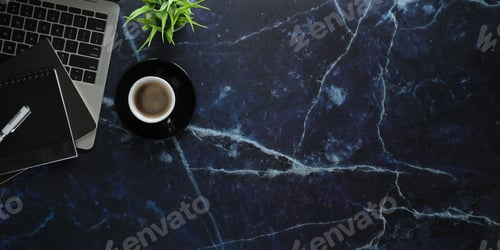 Preview: Top view image of coffee cup putting on marble texture working desk.