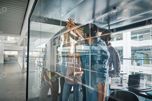 Preview: Cheering businesspeople high fiving together after an office brainstorming session