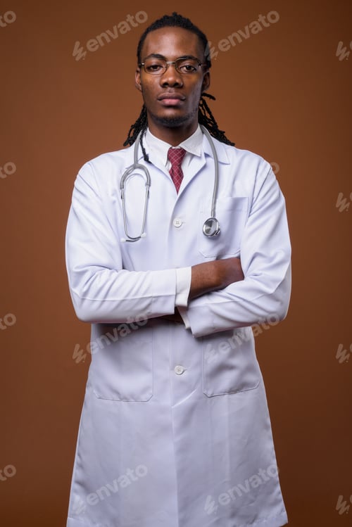 Preview: Young handsome African man doctor against brown background