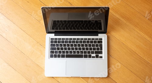 Preview: Laptop open on wooden floor, Home office concept