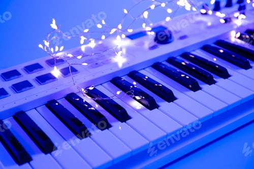 Preview: Musical keys and a garland on a blurred background with neon lighting.