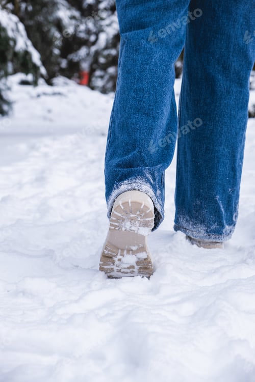 Preview: woman legs in winter boots making step in snow