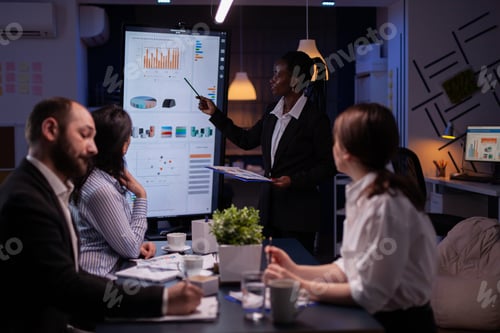 Preview: Workaholic african american leader standing in front of presentation monitor explaining marketing