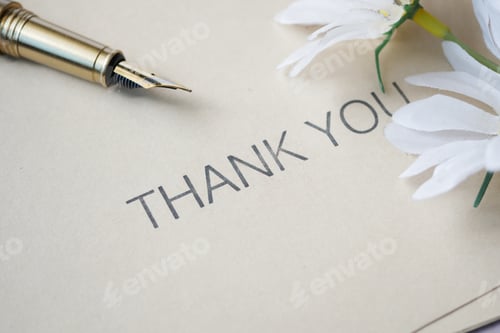 Preview: close up of thank you message , fountain pen and flower on table