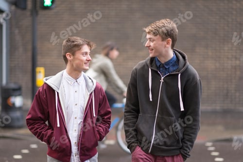 Preview: Two male friends crossing road