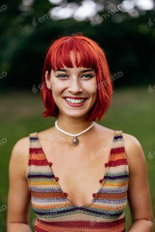 Preview: Smiling Woman Outdoors With Vibrant Red Hair and Striped Top