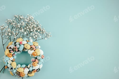 Preview: Handmade diy home interior decoration wreath with colorful easter eggs over blue background