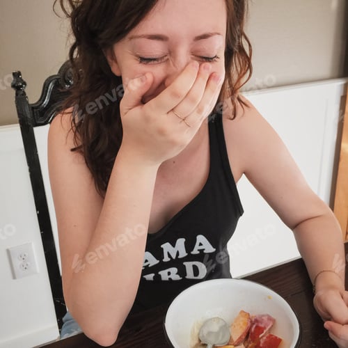 Preview: Happy Young Woman Laughing Indoors Near Fruit Bowl