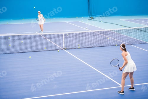 Preview: Two Sportswomen Playing Tennis in Court