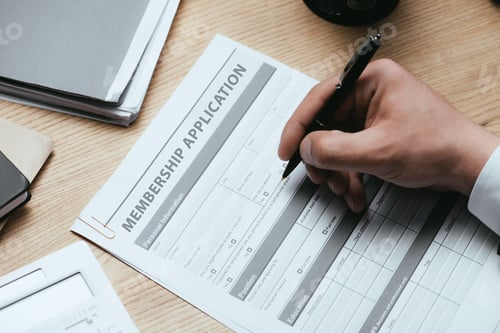 Preview: cropped view of man filling in Membership Application Form Register Concept