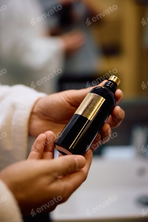 Preview: Close up of man using perfume after a bath.