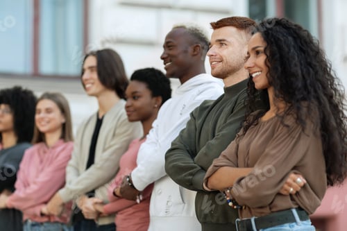 Preview: International group of cheerful students holding hands