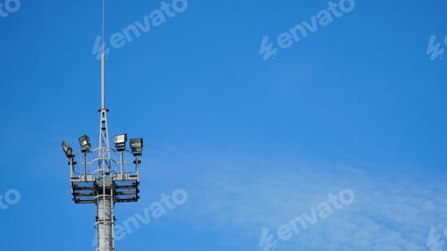Preview: High lighting mast against the blue sky. View from below. Full height.