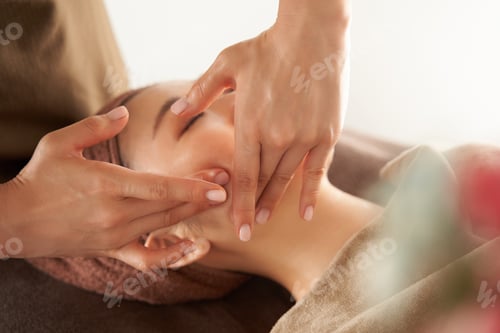 Preview: Japanese woman receiving a facial massage at an aesthetic salon