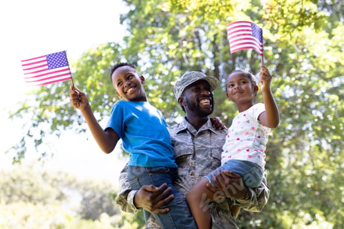 Preview: African American man wearing a military uniform holding his children