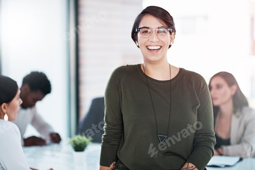 Preview: Portrait of a businesswoman in an office with her colleagues in the background