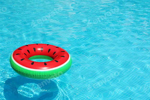 Preview: Inflatable ring floating in pool on sunny day