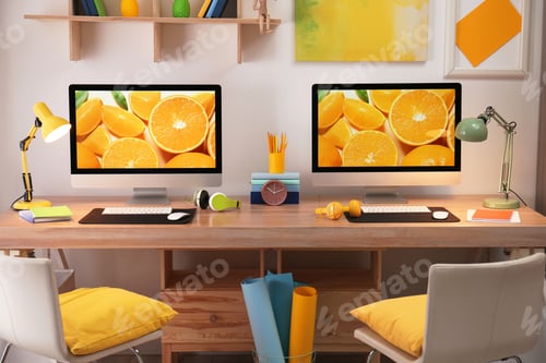 Preview: Modern workplace with large desk and computers in room. Stylish interior