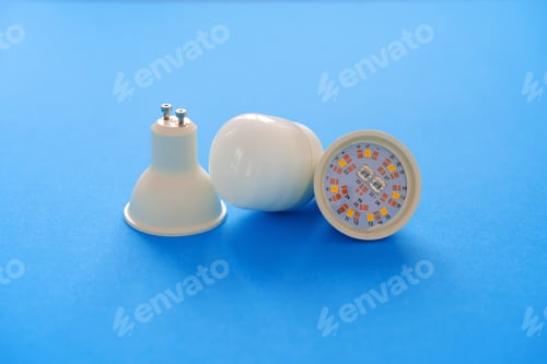 Preview: Light bulbs on blue paper background close up