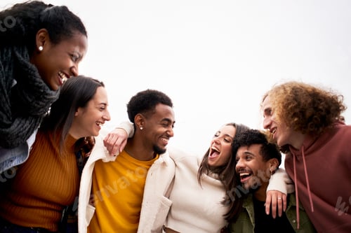 Preview: Multi-ethnic group of friends hugging and having fun. Isolated young smiling people laughing
