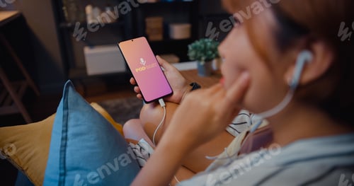 Preview: Young attractive Asia lady wear headphones using phone listen digital music podcast online channel.