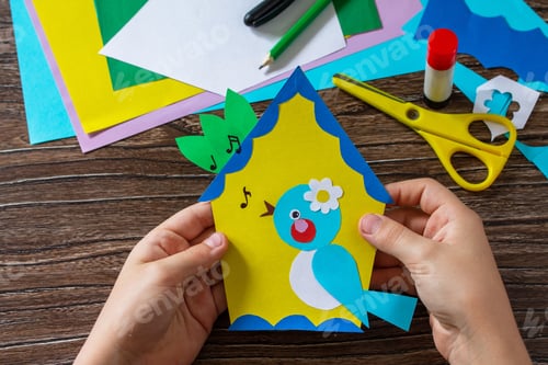 Preview: Spring postcard birdhouse with a bird on a wooden table. Handmade