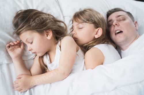 Preview: Kids, daughters, dad sleep together in bed on pillows under blanket. Father is snoring hard. Family